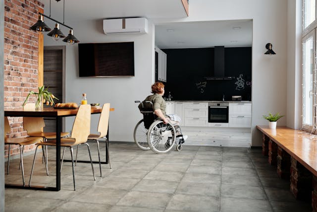 a tenant in a wheelchair going to their kitchen